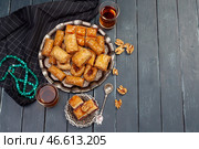 Top view of big metal tray with turkish baklava on planked wooden table. Стоковое фото, фотограф Сергей Толмачёв / Фотобанк Лори