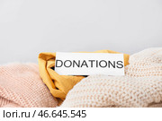 Различная одежда и бумага со словом Жертвоприношения на светлом фоне. Стоковое фото, фотограф Pixel_shot / Фотобанк Лори