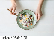 Женщина ест вкусный рис с фасолью и овощами за столом, вид сверху. Стоковое фото, фотограф Pixel_shot / Фотобанк Лори