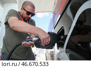 Россия. Заправка автомобиля с помощью топливораздаточного крана. Алексей Белкин/NEWS.ru/TACC. Стоковое фото, фотограф Белкин Алексей / ТАСС / Фотобанк Лори