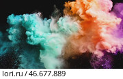 Explosion of bright colorful paint on black background. Burst of multicolored powder. Abstract pattern of colored dust splash. Turquoise and orange pigment scatter in different directions. Стоковое AI-видео, аниматор Ирина / Фотобанк Лори