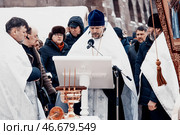 Saint Petersburg, Russia, 19 January 2022, Priest consecrate water, hold cross. Редакционное фото, фотограф Spirit River / Фотобанк Лори