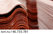Stack red roof tiles, raw material for industrial of construction. Стоковое фото, фотограф David Kashakhi / Фотобанк Лори