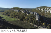 Panorama of valley of gorge rocky ledges with gardens of trees and houses. Стоковое фото, фотограф David Kashakhi / Фотобанк Лори