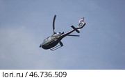 Helicopter hovering against bright sunny and cloudy sky. Стоковое фото, фотограф David Kashakhi / Фотобанк Лори