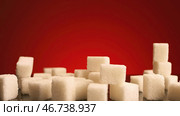 Concept of sweets and unhealthy diet, pressed sugar falling down to a pile of white pieces. Стоковое фото, фотограф David Kashakhi / Фотобанк Лори