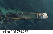 Aerial view of the rusty sunken ship stuck on a rocky shoal. Стоковое фото, фотограф David Kashakhi / Фотобанк Лори