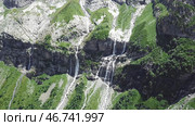 Waterfall flowing down from high mountains on a Sunny day. Стоковое фото, фотограф David Kashakhi / Фотобанк Лори