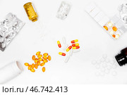 Pillbox by days of the week with fish oil and various pills, capsules and jars scattered on a white background, top view. Стоковое фото, фотограф Кашапова Эльвира / Фотобанк Лори