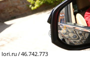 Blind Spot Monitoring system warning light icon in side view mirror of a modern vehicle. Стоковое фото, фотограф David Kashakhi / Фотобанк Лори