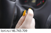 Woman with manicure switches turn signal lever or turns on wipers. Стоковое фото, фотограф David Kashakhi / Фотобанк Лори