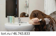 Woman crying in the bathroom after a quarrel with her husband, her husband calms. Стоковое фото, фотограф David Kashakhi / Фотобанк Лори