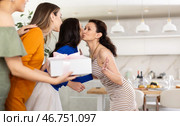 Three women have arrived for birthday celebration and presenting gift to birthday woman. Стоковое фото, фотограф Яков Филимонов / Фотобанк Лори