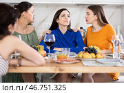 Sad Caucasian woman sits silently in kitchen, female friends sympathize and comfort woman. Стоковое фото, фотограф Яков Филимонов / Фотобанк Лори