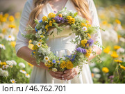 A beautiful summer wreath of wildflowers in the hands of a girl. Summer spring time. Summer solstice background. The feast of Ivan Kupala. Стоковое AI-изображение, AI-художник Photojuli / Фотобанк Лори