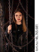 Model Poses With Chains in a Creative Studio Setting Highlighting Youthful Expression and Style. Стоковое фото, фотограф Aleksandr Golubev / Фотобанк Лори