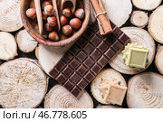 Различные кусочки шоколада с орехами на деревянных пеньках. Стоковое фото, фотограф Pixel_shot / Фотобанк Лори