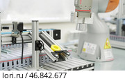Close up of yellow object created by 3D printer in modern workshop. Scene. Technological background of robotic mechanism making a detail, science concept. Стоковое фото, фотограф Данил Руденко / Фотобанк Лори