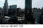 Summer landscape on a built-up city from a height. Stock footage. High-rise beautiful glass offices standing on the banks of the river and green parks for walking and a visible road for traffic. Стоковое фото, фотограф Данил Руденко / Фотобанк Лори