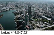 Tall buildings with blue windows taken from a drone. Stock footage. A magnificent landscape of a big city with beautiful houses and parks around the river. Стоковое фото, фотограф Данил Руденко / Фотобанк Лори