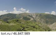 Top view of green mountain valley on sunny day. Action. Beautiful mountain valley with green stepped slopes. Mountain landscape with bright green slopes on sunny summer day. Стоковое фото, фотограф Данил Руденко / Фотобанк Лори