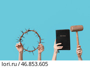 Женские руки с венцом из терновника, молотом и Священной Библией на цветном фоне. Концепция Великого Пятницы. Стоковое фото, фотограф Pixel_shot / Фотобанк Лори