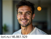 A young Brazilian man radiates joy and charm as he stands in a contemporary indoor environment. His expressive smile captures a sense of charisma and approachability, inviting connection. Стоковое AI-изображение, AI-художник Юлия Петровская / Фотобанк Лори