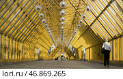 View inside of Andreyevskiy bridge with bright yellow metal beams and hanging lanterns. Стоковое фото, фотограф David Kashakhi / Фотобанк Лори