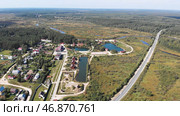 Aerial view of countryside area with village, forest, ponds, rivers and fields in the summer time under cloudy sky. Стоковое фото, фотограф David Kashakhi / Фотобанк Лори