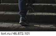 A boy with a backpack behind him, school, climbs the stairs to the top. Стоковое фото, фотограф David Kashakhi / Фотобанк Лори