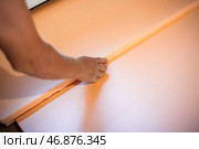 Worker lays polystyrene foam on the floor. Insulation of the house, installation of underfloor heating. Стоковое фото, фотограф Коханова Наталья / Фотобанк Лори