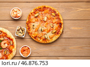 Вкусная пицца из морепродуктов и ингредиенты на деревянном фоне. Стоковое фото, фотограф Pixel_shot / Фотобанк Лори