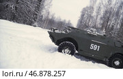 Soldier throws a hand grenade into a battle tank or armored personnel carrier, winter backround, Soldier throws a training grenade into a tank in the winter forest. Стоковая иллюстрация, иллюстратор David Kashakhi / Фотобанк Лори