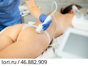 Young girl lying in spa while having body treatment procedures with technologies shrink pores and repair damaged skin. Hardware cosmetology and dermatology. Стоковое фото, фотограф Яков Филимонов / Фотобанк Лори
