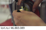 Man fixes detail on welding machine. Стоковое фото, фотограф David Kashakhi / Фотобанк Лори