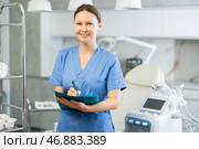 Experienced female doctor cosmetologist ready to receive clients in his office. In background Rf cosmetology machine. Стоковое фото, фотограф Яков Филимонов / Фотобанк Лори