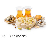 Вкусная халва тахини с фисташками, пахлавой и чаем на белом фоне. Стоковое фото, фотограф Pixel_shot / Фотобанк Лори