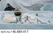 Close up of medical tools, iodine cup and white cotton balls and sterile gauze, concept of medicine. Стоковое фото, фотограф David Kashakhi / Фотобанк Лори