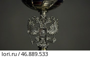 Low key image of trophy over wooden table and dark background, with abstract shiny lights. Стоковое фото, фотограф David Kashakhi / Фотобанк Лори