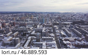 Aerial view of the city and many houses, roads, and yards in the winter time. Стоковое фото, фотограф David Kashakhi / Фотобанк Лори