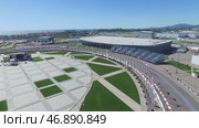 Building site of stadium for racing near town and mountains at summer sunny day. Стоковое фото, фотограф David Kashakhi / Фотобанк Лори