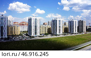 Buildings of a new modern sleeping area on blue cloudy sky background. Стоковое фото, фотограф David Kashakhi / Фотобанк Лори