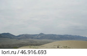 The desert against the white sky behind the big slightly green mountains and all in the sand. Стоковое фото, фотограф David Kashakhi / Фотобанк Лори