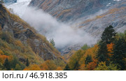 Misty low clouds mysteriously move in mountain autumn valley. Стоковое фото, фотограф David Kashakhi / Фотобанк Лори