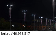 Beautiful glowing garlands on lampposts in city. Стоковое фото, фотограф David Kashakhi / Фотобанк Лори