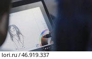 Digital art concept, graphic designer using a stylus pen and a tablet to draw the illustration of a young man. Стоковая иллюстрация, иллюстратор David Kashakhi / Фотобанк Лори