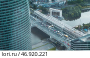 View from high-rise building of part of neighboring office skyscraper and bridge with cars. Стоковое фото, фотограф David Kashakhi / Фотобанк Лори