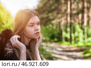 Model Poses Gracefully in a Lush Outdoor Setting During Golden Hour. Стоковое фото, фотограф Aleksandr Golubev / Фотобанк Лори