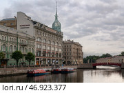 St. Petersburg, Russia, 07.20.2024: View of the historical building of the store "At the Red Bridge" of the Belgian-Dutch trading company "S.Esders and K.Scheifals" on the Moika River embankment. Редакционное фото, фотограф Ula Ulachka / Фотобанк Лори
