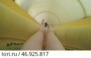 Woman with yellow fun slides water slides. Стоковое фото, фотограф David Kashakhi / Фотобанк Лори